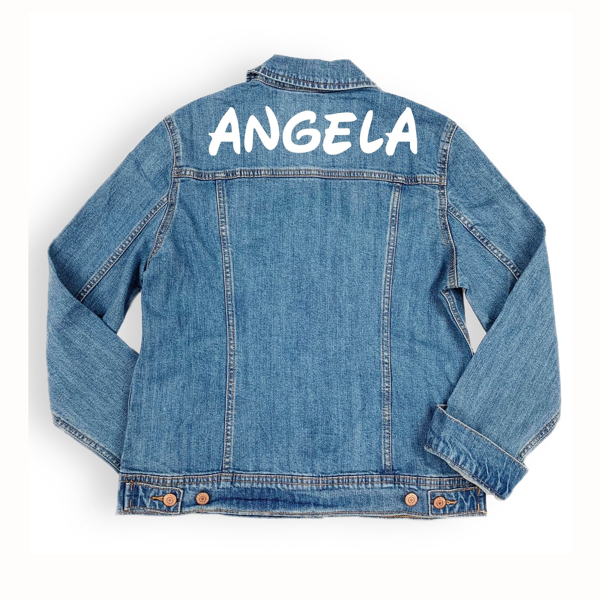 A denim jacket is customized with "Angela" across the shoulders in a white font.