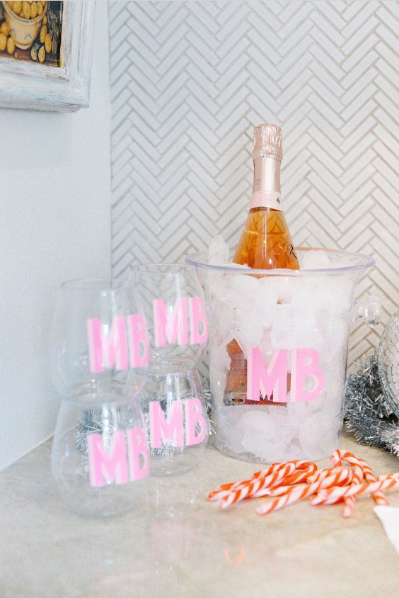 A clear ice bucket with "KE" monogrammed on the front in pink