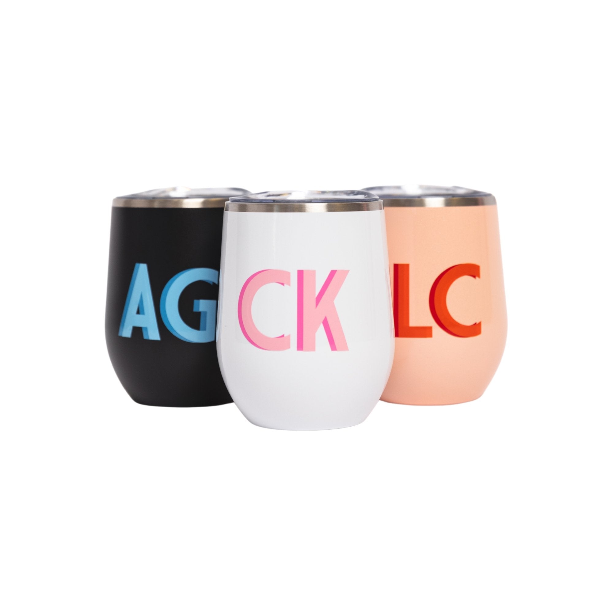 A group of wine tumblers are customized with a shadow monogram