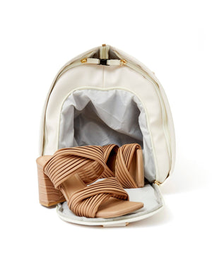 A pocket inside a duffel bag lays open revealing the spacious interior can fit a pair of shoes.