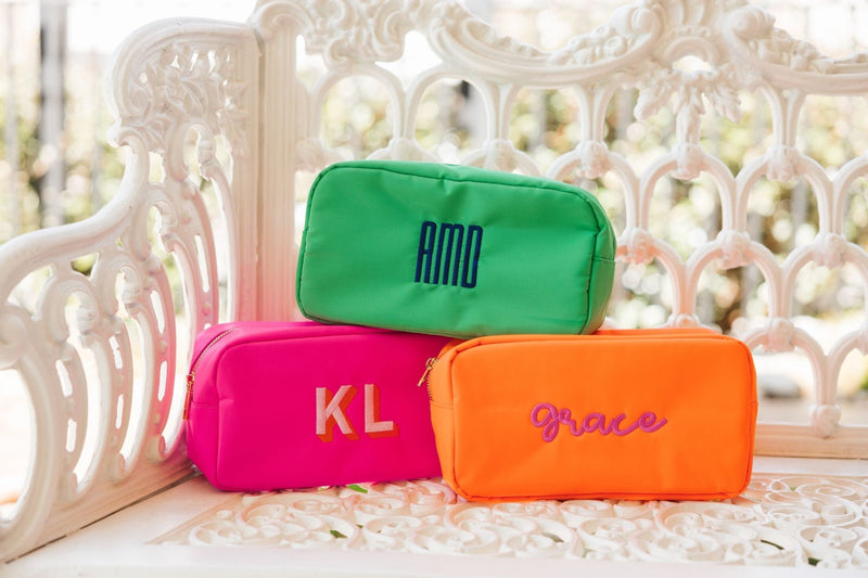 Bright colored embroidered pouches customized with names and monograms