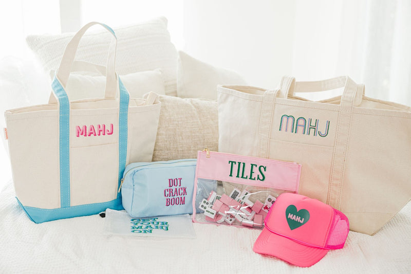 An array of custom Mahjong products sits on a bed