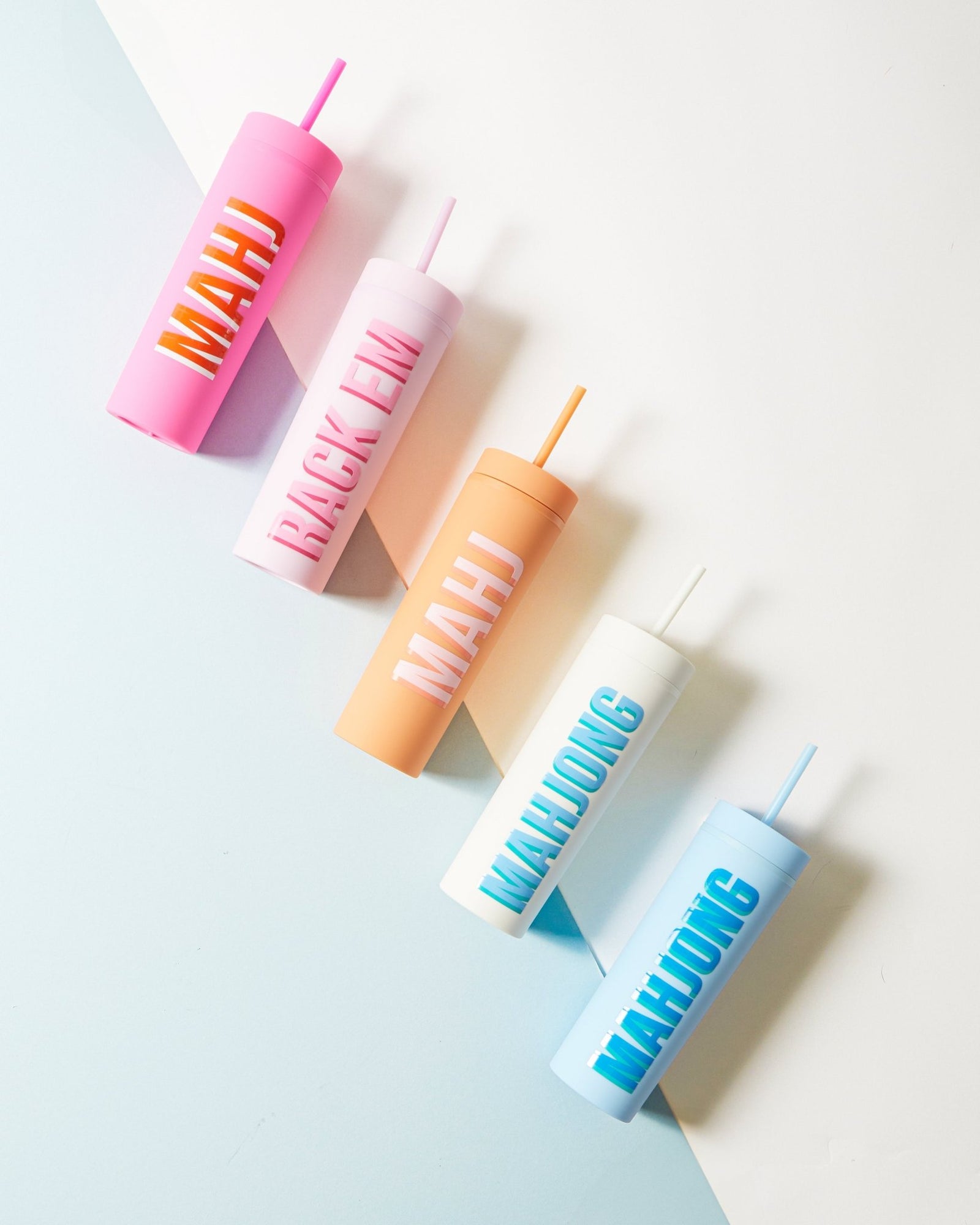 Three Mahjong themed tumblers in blue, pink, and orange