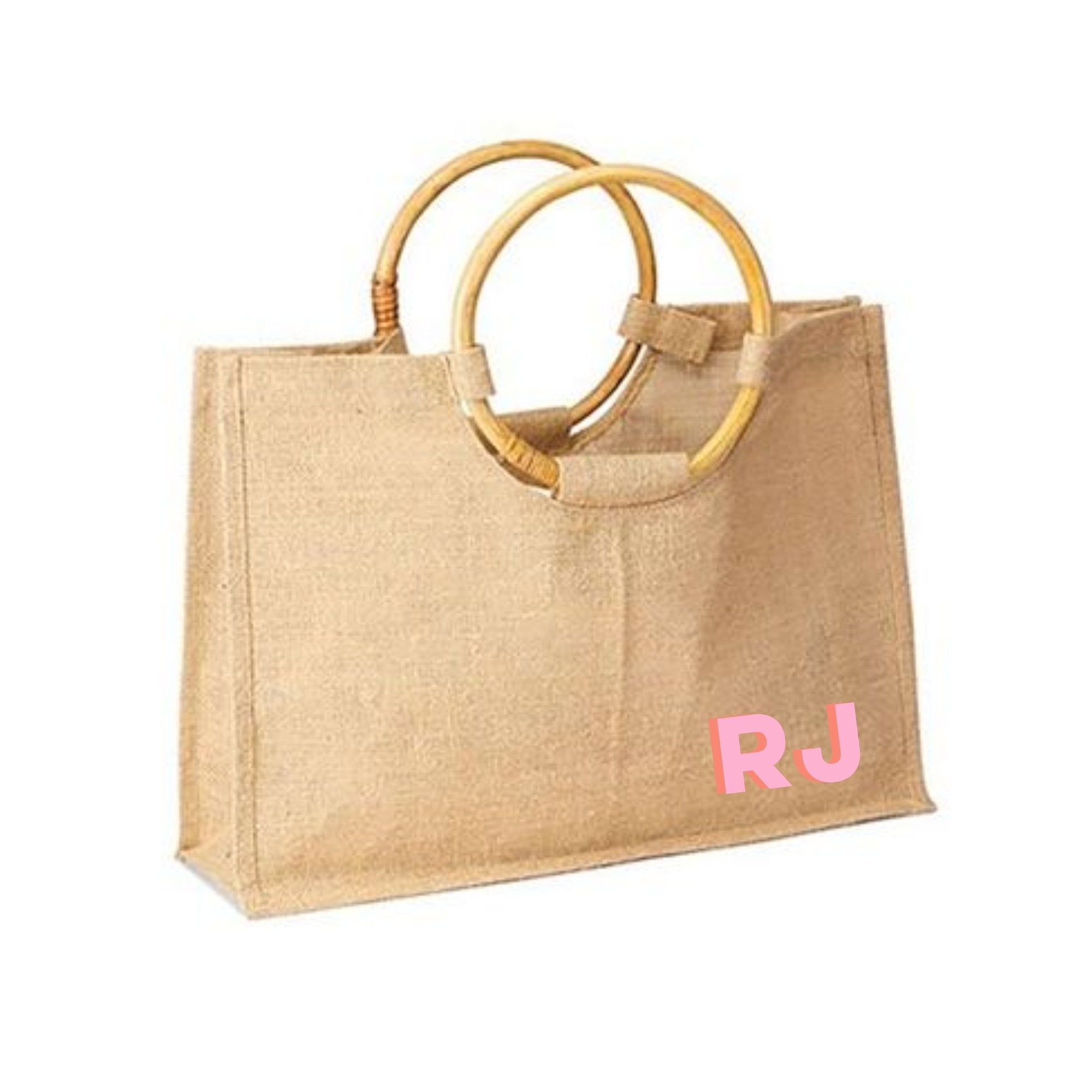 A bamboo jute is customized with a pink monogram on the bottom corner