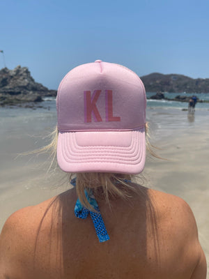 Personalized shadow monogram trucker hat with embroidered initials, shown in solid color with mesh back