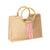 A bamboo jute bag is customized with a pink and melon stripe and monogram 