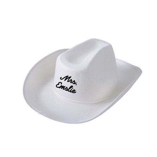 A white cowboy hat is customized with a last name.