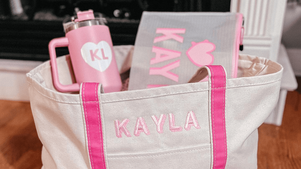 Sprinkled With Pink’s monogrammed tote stuffed with a matching pink tumbler and pool pouch