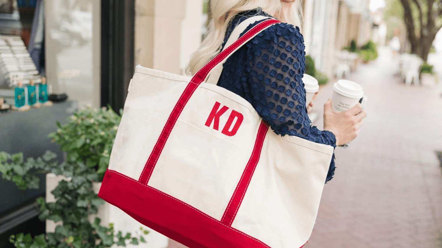 Woman Carrying White and Red Embroided Monogram Tote