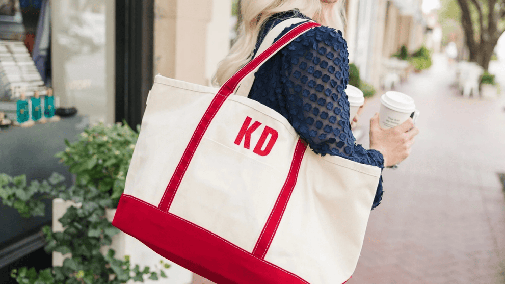 Woman Carrying White and Red Embroided Monogram Tote