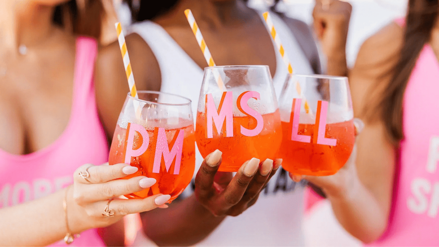 Women Doing a Celebratory Toast in Monogrammed Wine Glasses