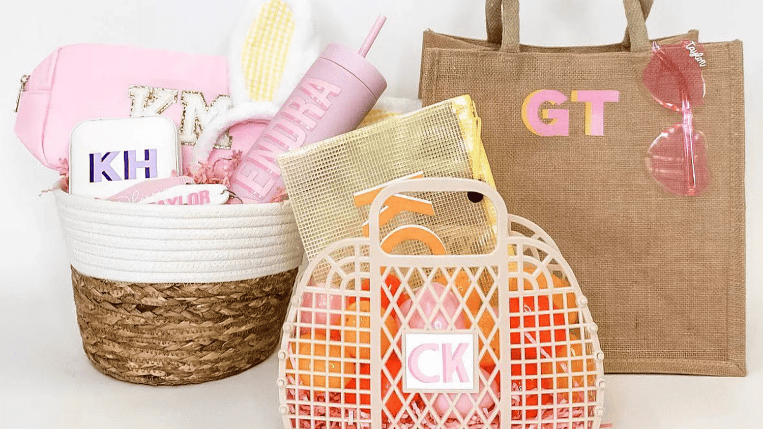 Assortment of Sprinkled With Pink birthday gifts: jute bags, jewelry cases, tumblers, etc.