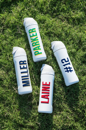 Four white 24 oz tumblers with flip-top lids, each personalized “MILLER,” “PARKER,” “LAINE,” or “#12.”