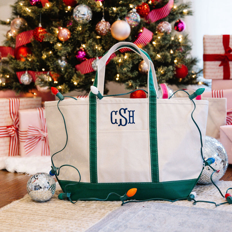 Personalized canvas tote bags under a Christmas tree, perfect holiday gifts.