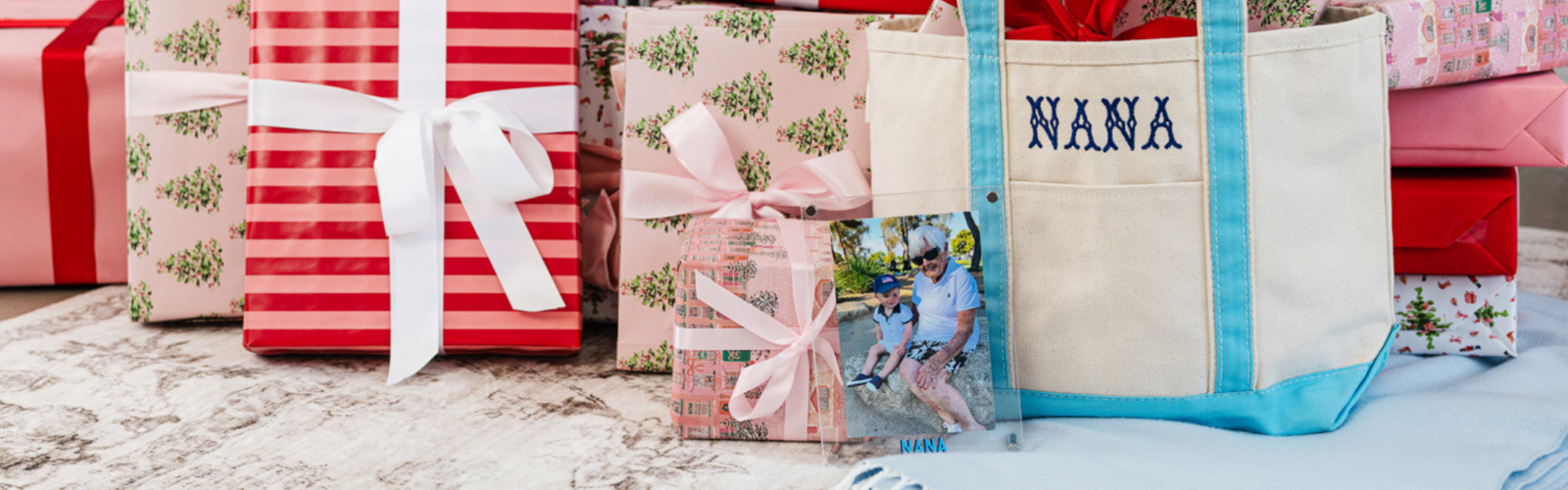 Christmas gift scene featuring a personalized tote bag and acrylic frame for Nana.
