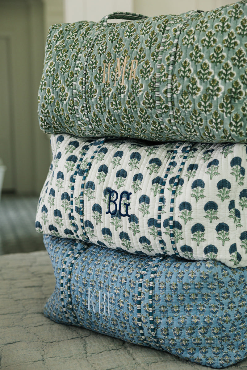Green embroidered block print duffel with monogram detail, perfect for personalized travel style.