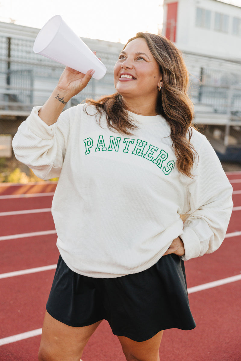 Cheering woman on track wearing Collegiate Embroidered Sweatshirt with green arched “PANTHERS”.
