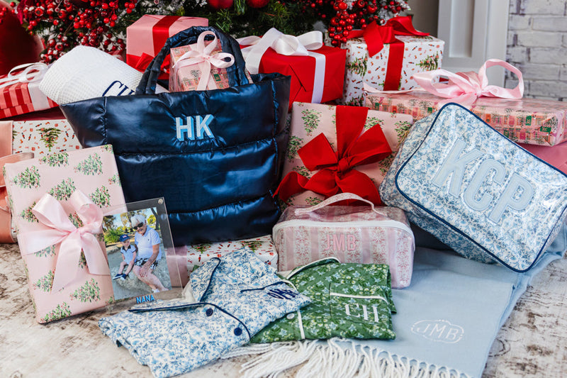 Holiday gift collection with embroidered duffle bags and personalized travel accessories