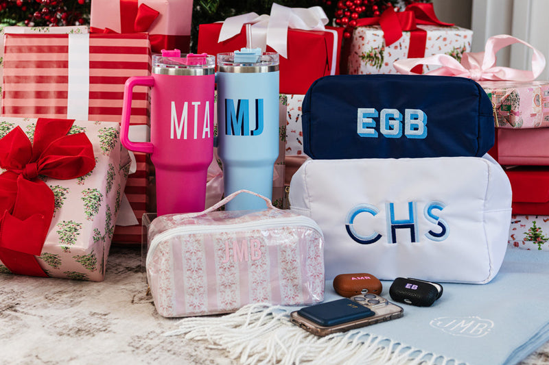 Personalized Christmas gifts featuring monogrammed pouches, and custom tumblers