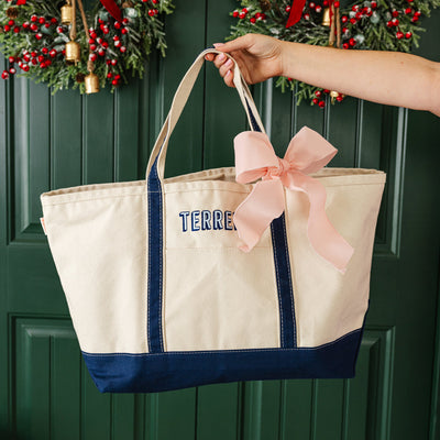 Personalized tote bag with pink bow, chic and practical holiday gift.