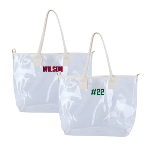Two clear vinyl tote bags with cream handles, embroidered with red “WILSON” and green “#22.”