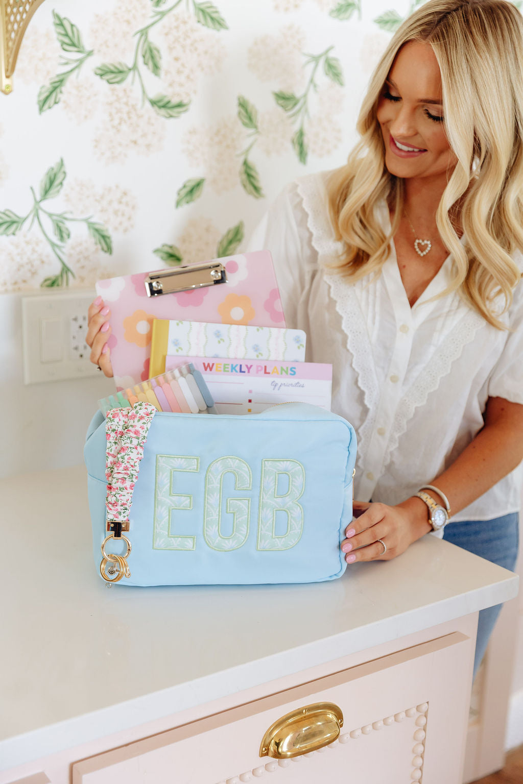 Blue nylon pouch set in large and extra-large sizes with embroidered monogram.