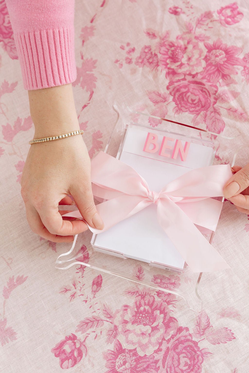 A clear acrylic notepad customized with initials