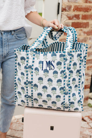 Blue floral Block Print Tote bag with monogram embroidery, carried for everyday use