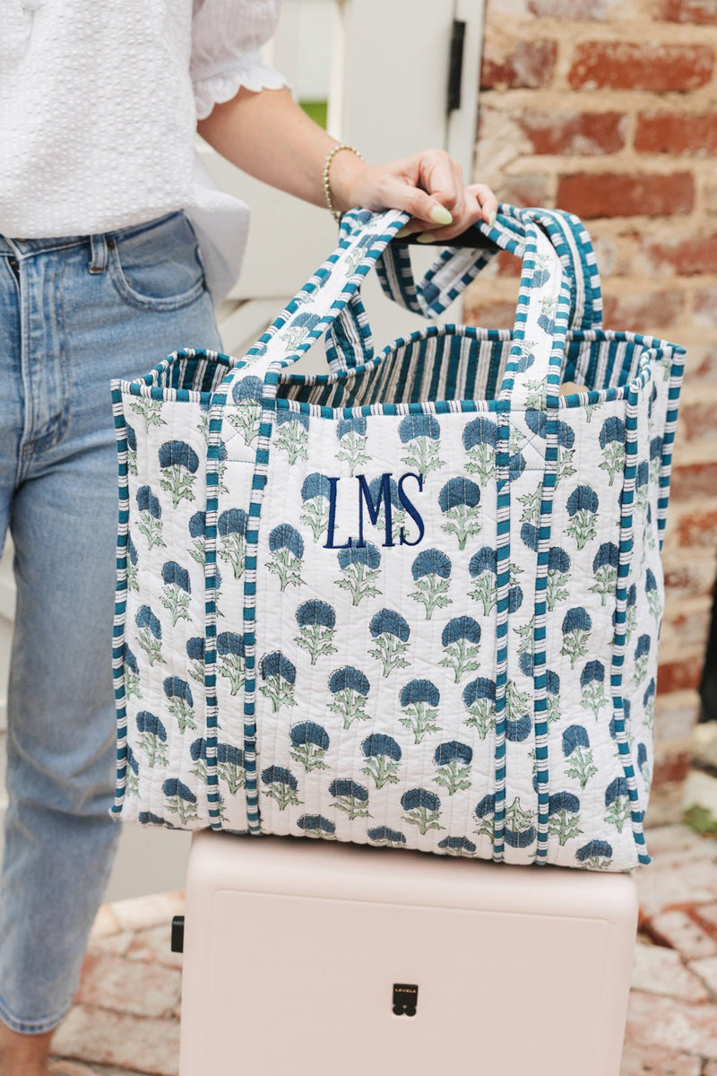 Blue floral Block Print Tote bag with monogram embroidery, carried for everyday use