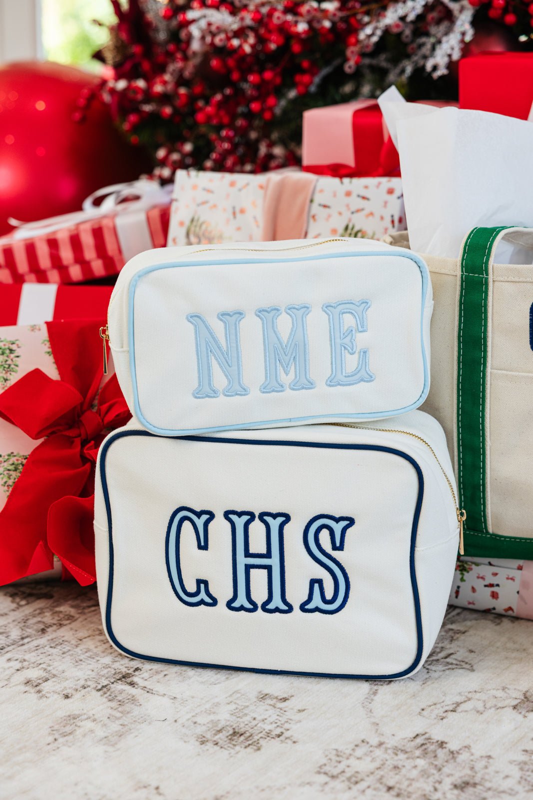 Pink embroidered canvas pouch set in two sizes, ideal for travel or gifts.