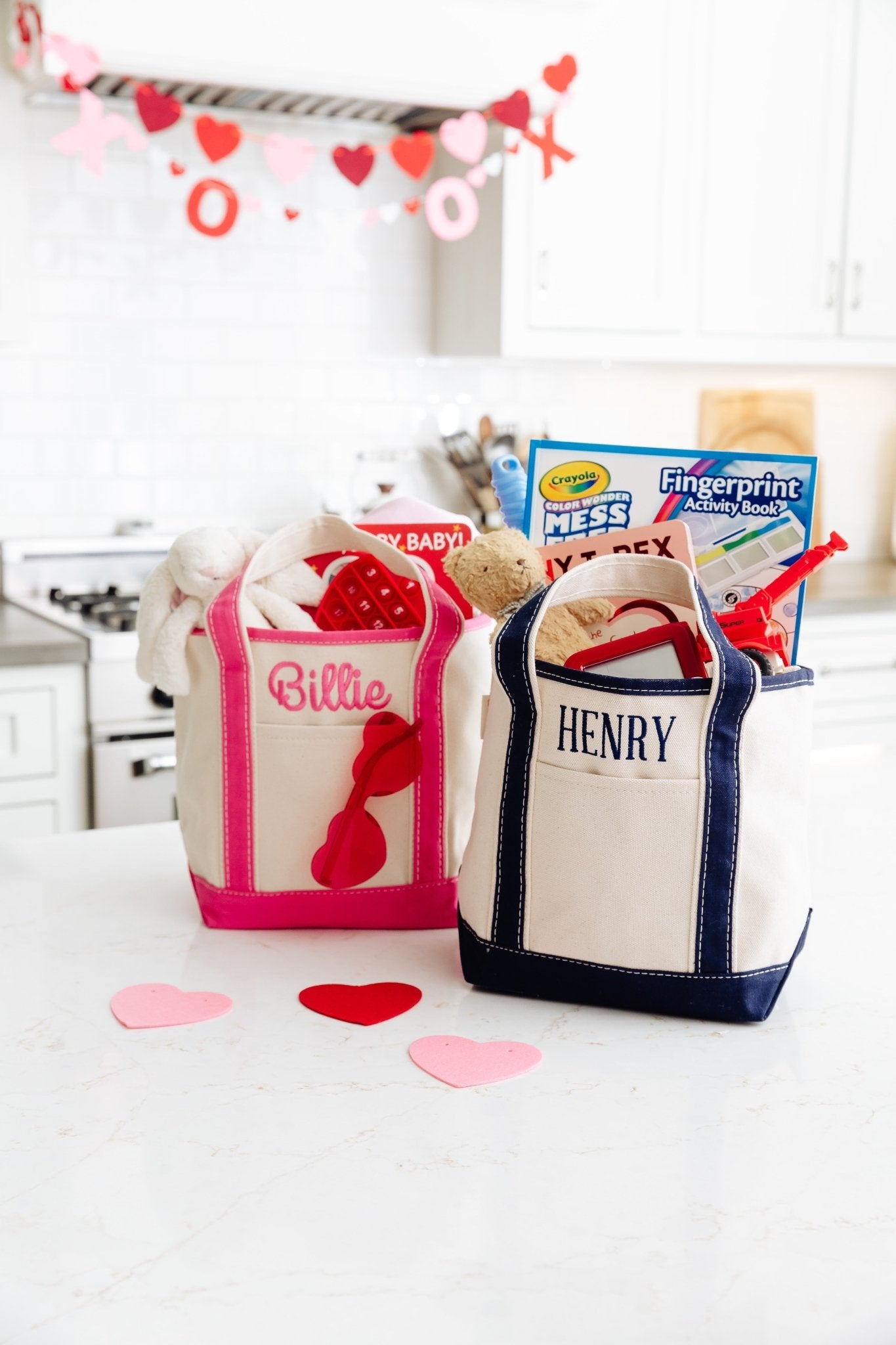 Three embroidered canvas totes in natural cream with blue, hot-pink, and natural trims, personalized “Chloe,” “GCM,” and “AD” fb-feed