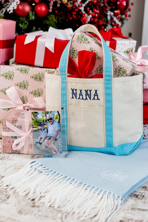 Custom monogrammed canvas tote bag with festive red ribbon, personalized holiday gift for grandma.