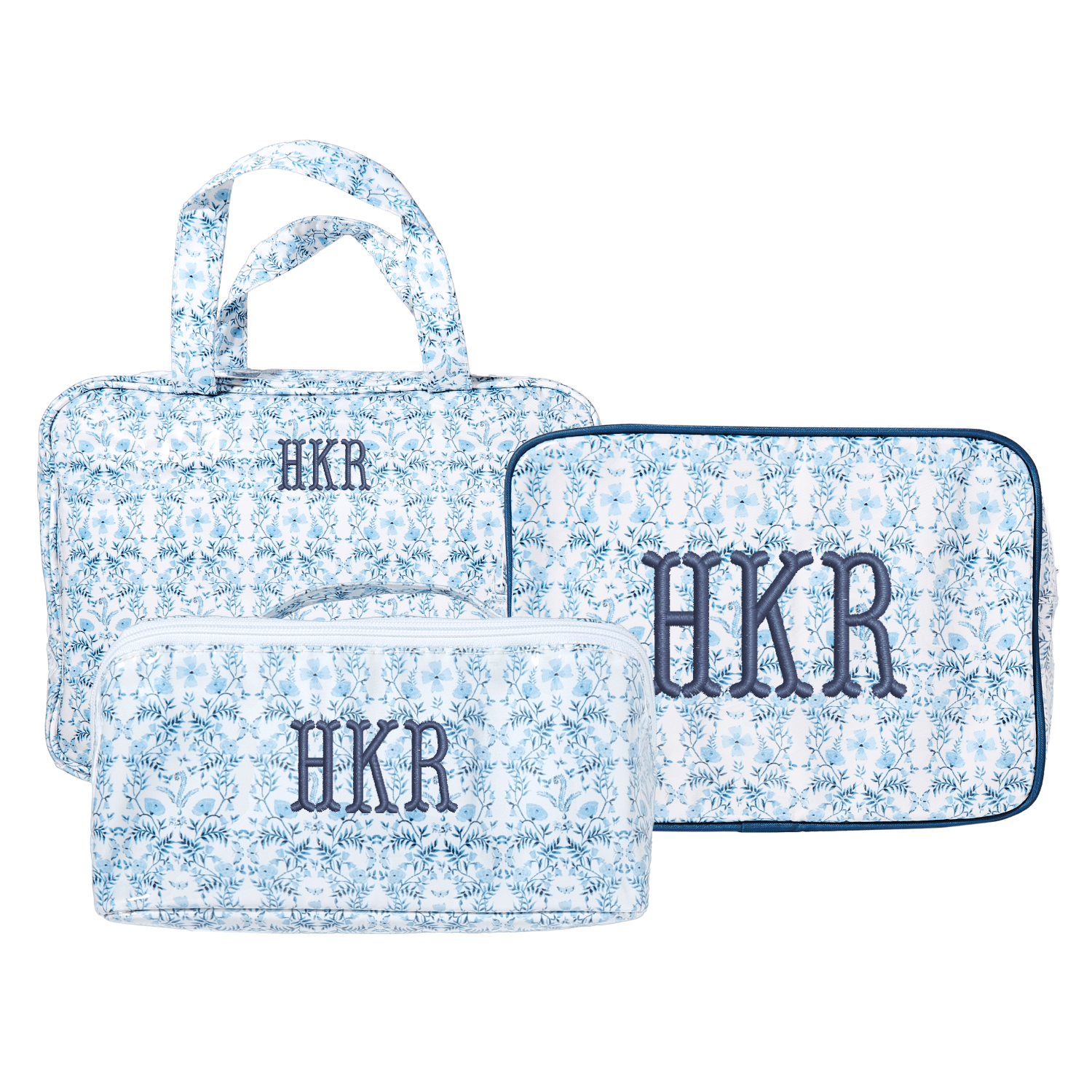 Blue floral clear coated essential set with monogram HKR, includes tote, pouch, and flat case.