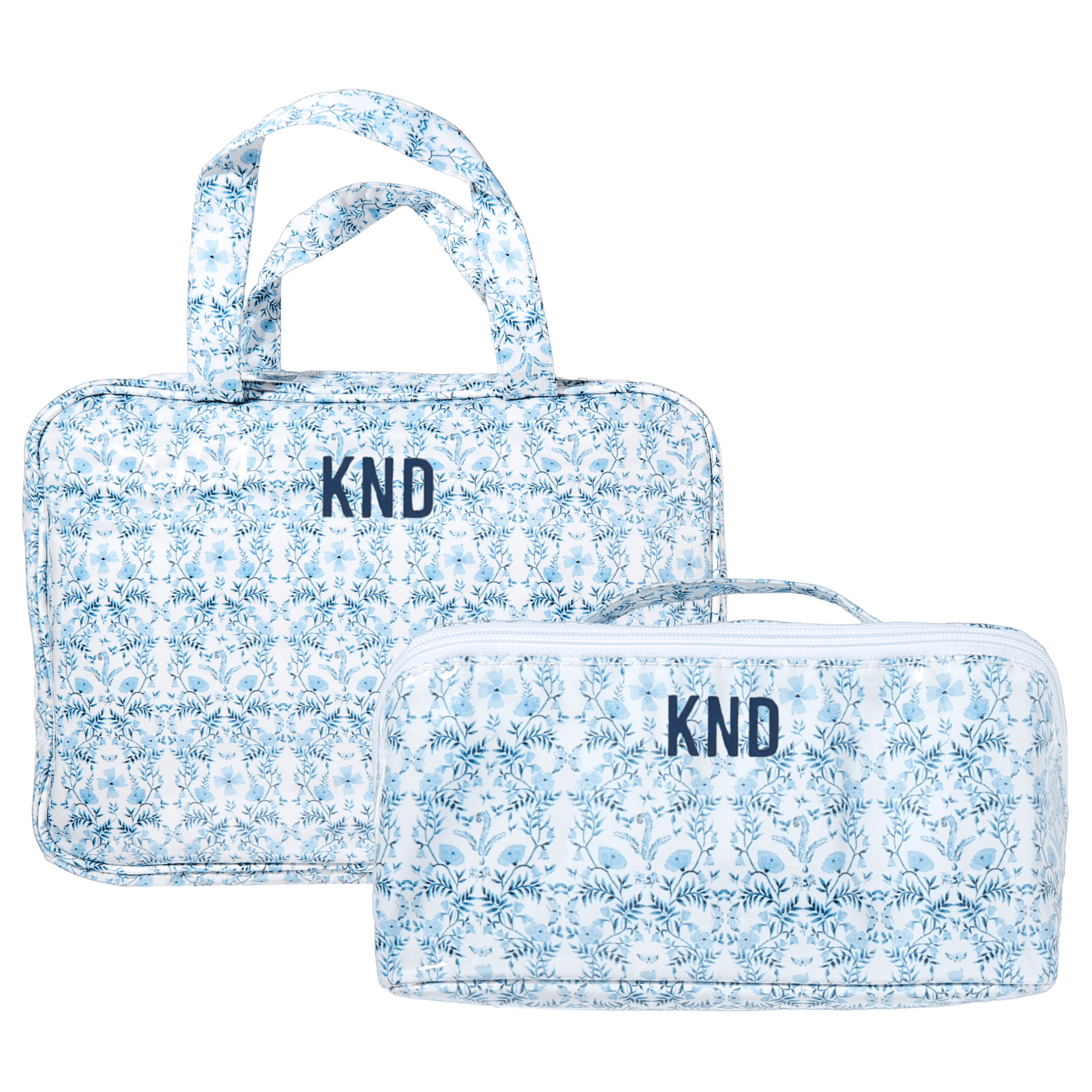 Blue floral Clear Coated Travel Set with monogram "KND," includes two matching cosmetic and travel bags.