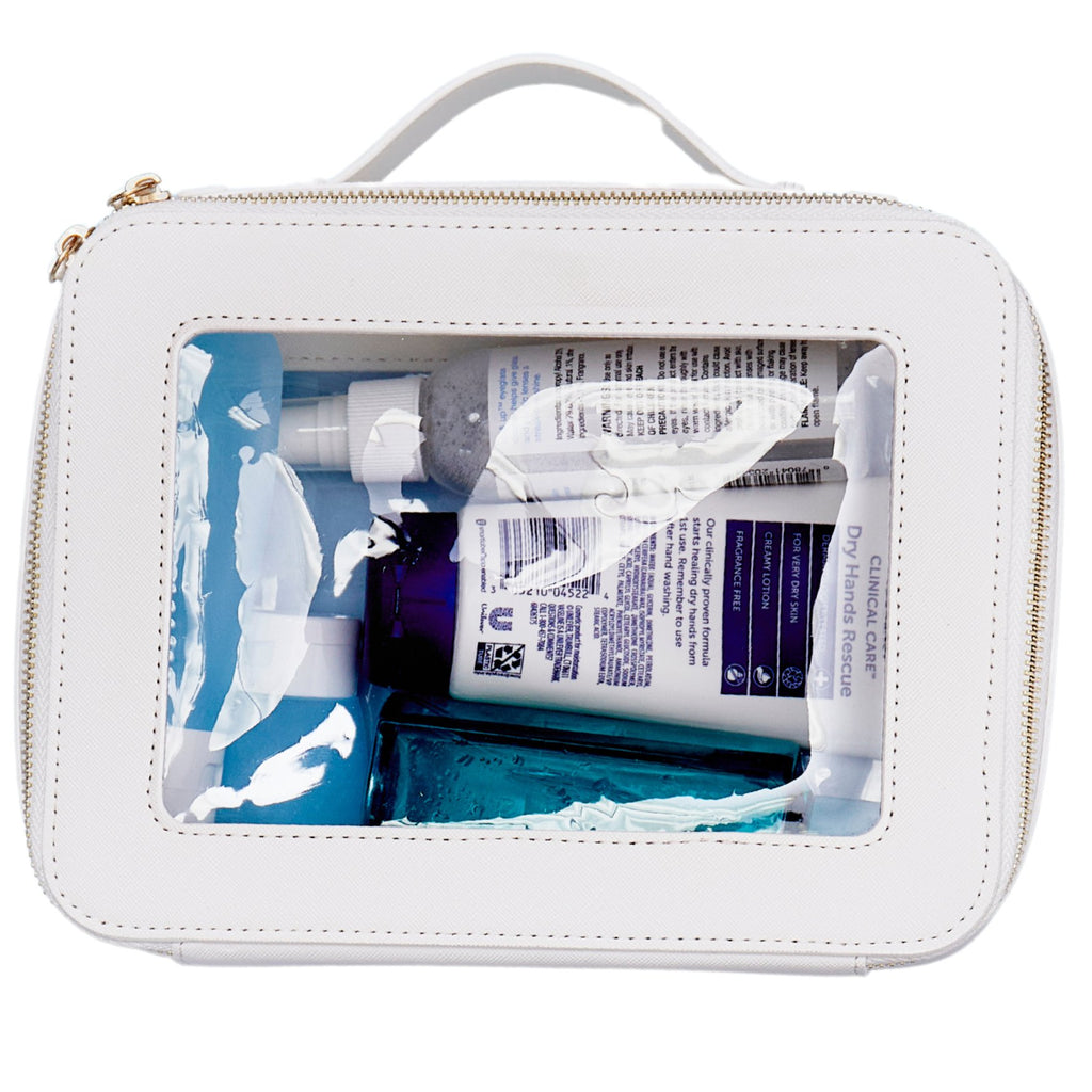 Top view of clear leather toiletry case with zippered opening and structured silhouette
