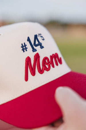 Close-up of Custom #'s Mom 3D Puff Vintage Trucker Hat with red brim and raised “#14’s Mom” script.