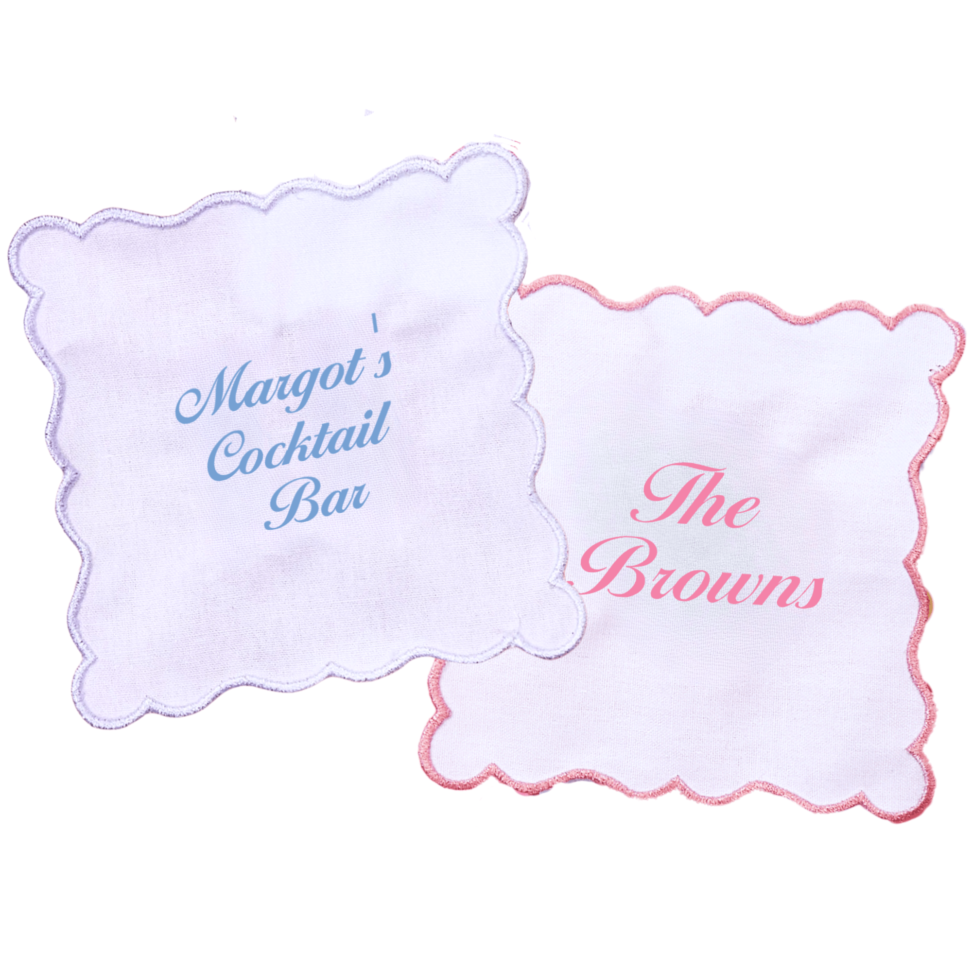 White cocktail napkins with scalloped edges, embroidered with “Margot’s Cocktail Bar” in blue and “The Browns” in pink.