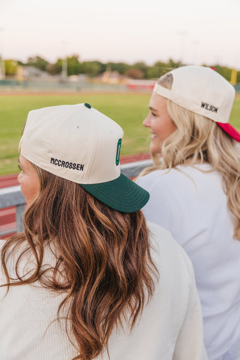 Two fans in personalized trucker hats, green and red brims, at track, Custom Sport 3D Puff Vintage Trucker Hat.