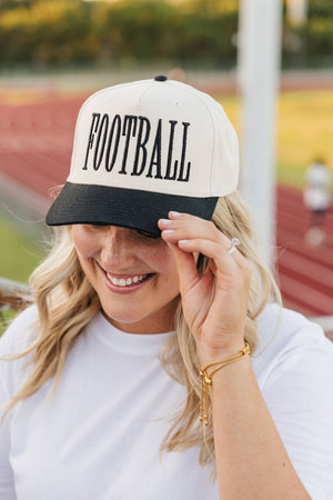 Cream and forest-green vintage trucker hat with bold “FOOTBALL” embroidery in classic serif lettering.