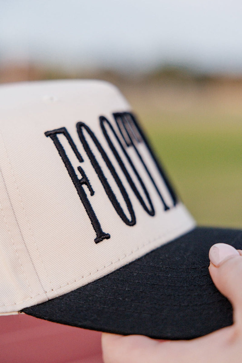 Close-up of bold 3D “FOOTBALL” embroidery on cream cap