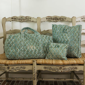 Embroidered block print duffel, tote, and flat pouch in green floral design, personalized with monograms.