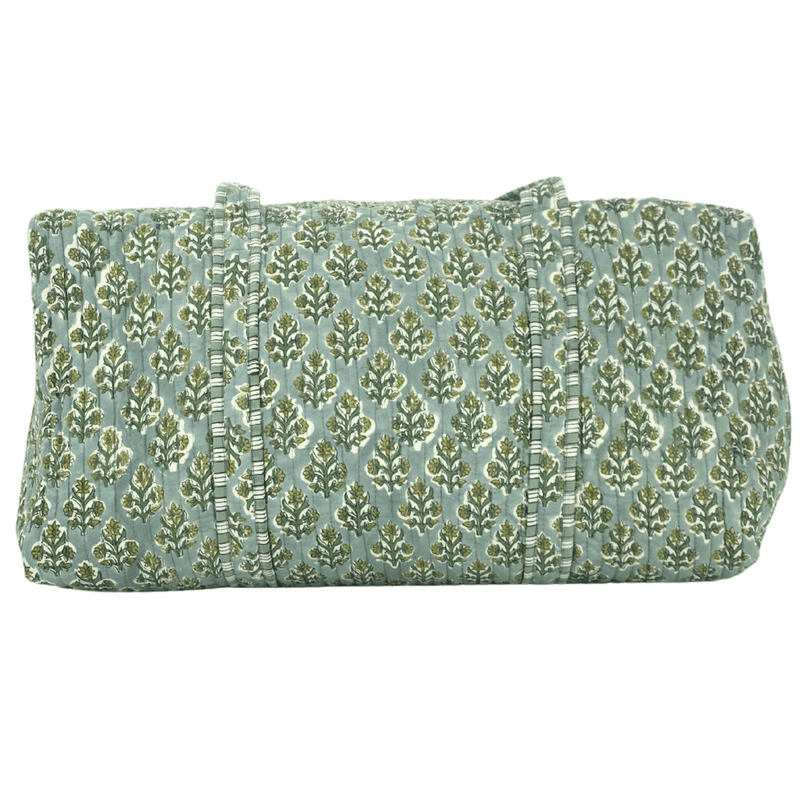 Close-up of green Embroidered Block Print Duffel bag with floral design and beige monogram, handmade travel accessory.