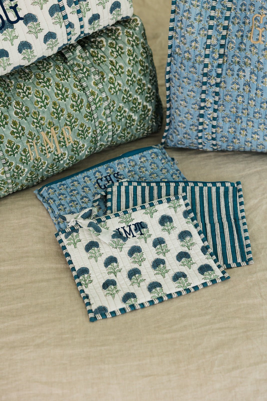 Set of Embroidered Block Print Flat Pouches in striped and floral prints, customized with embroidered initials.