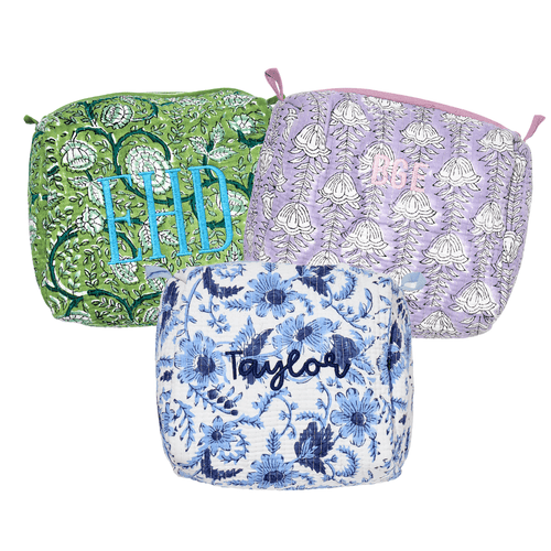 Assorted Embroidered Block Print Pouches in vibrant green, pink, lavender, and blue floral patterns with personalized monograms—perfect for travel or everyday use.