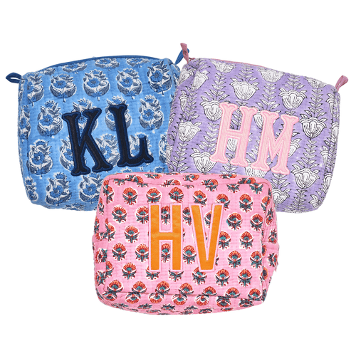 A colorful set of three Embroidered Block Print Pouches with Applique, featuring custom monograms in bold, vibrant thread. Each pouch displays a unique floral block print design in blue, purple, and pink tones, making them perfect for personalized travel or cosmetic storage.