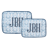 Two embroidered blue floral clear-coated pouches in large and small sizes with “JBH” monogram in bold navy letters.