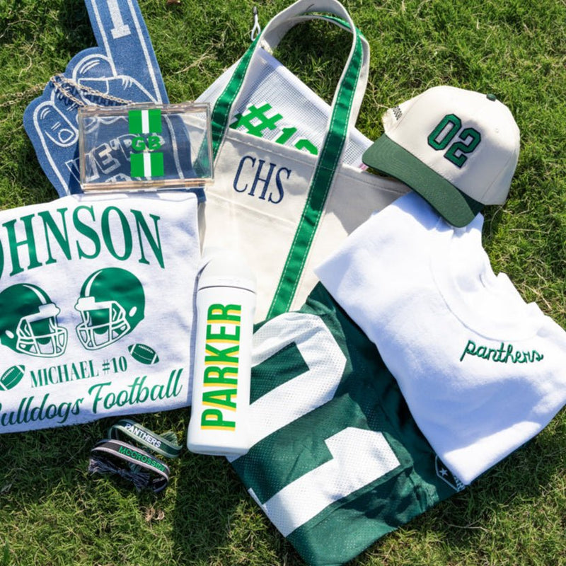 Collection of sports-themed merchandise including a sweatshirt, trucker hat, and pouches.