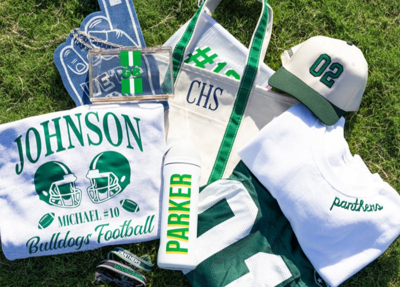 Natural canvas tote with green trim and “CHS” embroidery, styled with gameday accessories