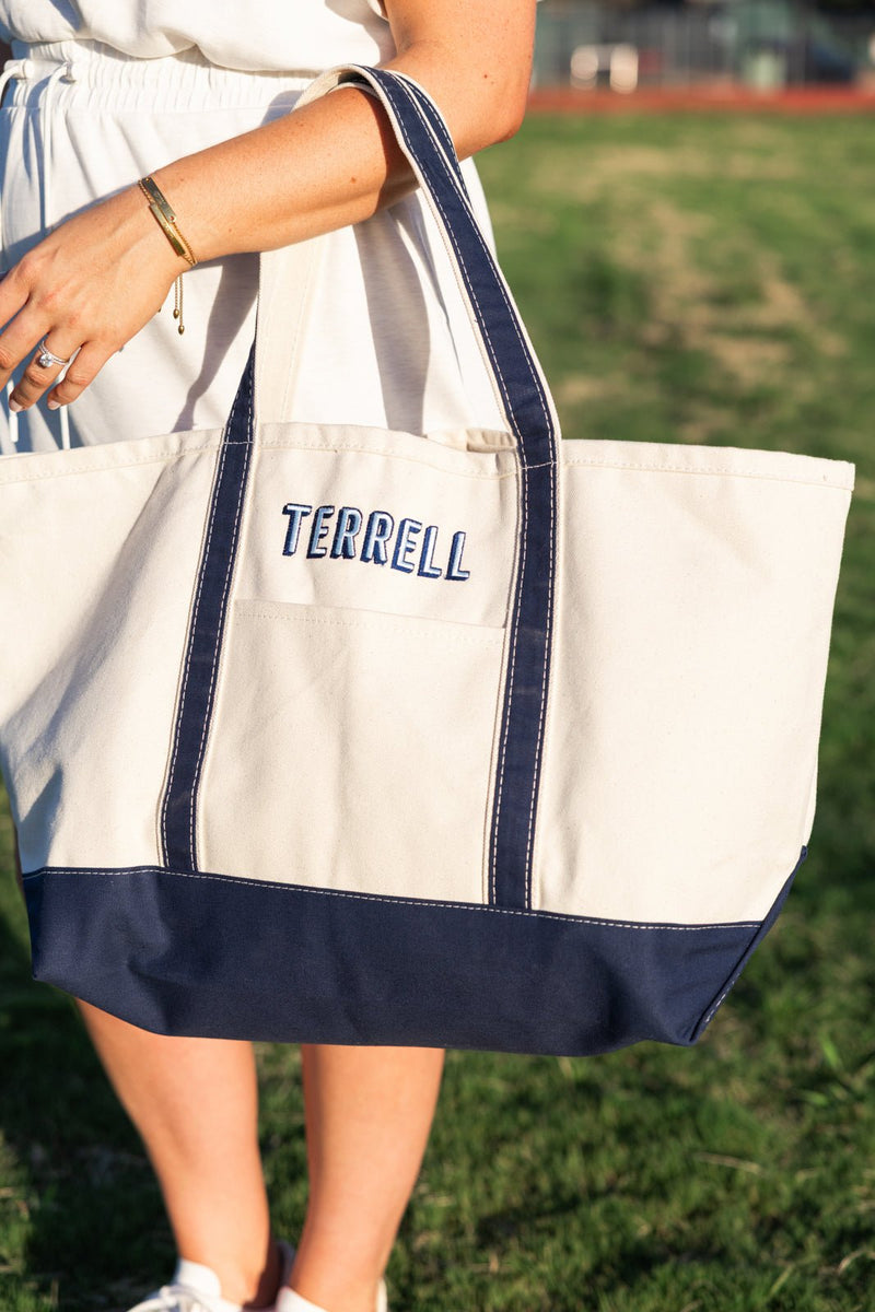 Natural canvas gameday tote with navy trim, sturdy handles and TERRELL embroidered in matching navy