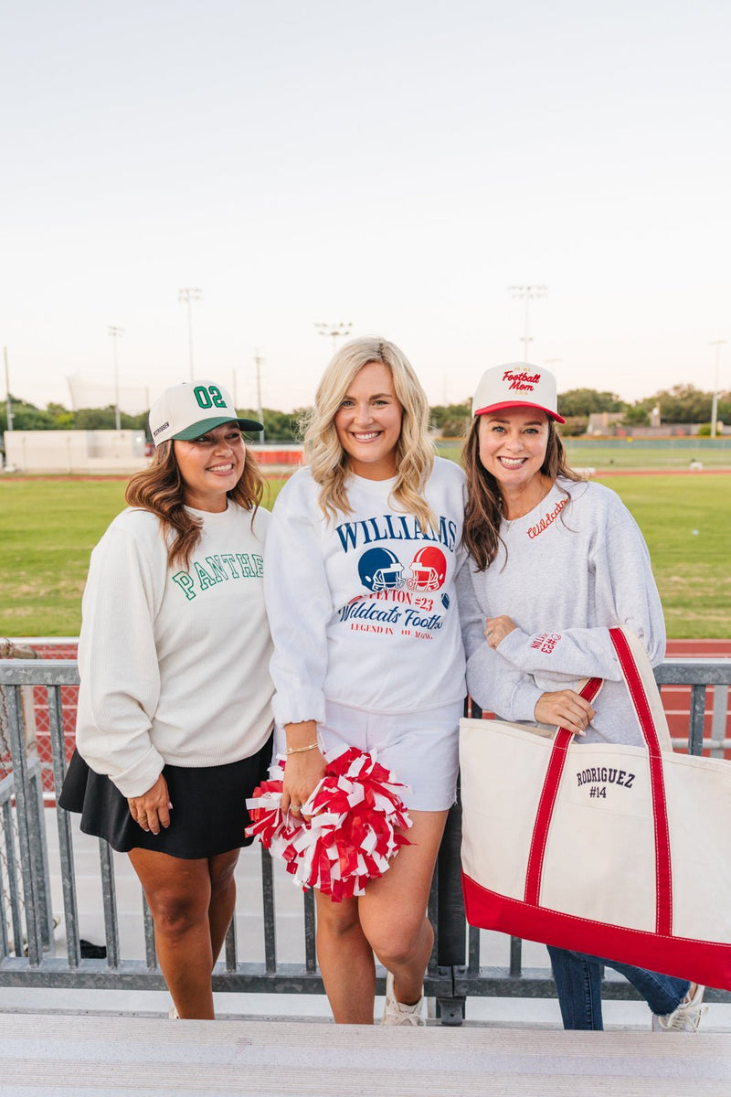 Three friends at the bleachers styling Embroidered Jersey Number Vintage Trucker Hats with custom numbers.